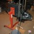 The oil pan and transmission cover are installed. The chain hoist helps balance the now offset load on the engine stand. Extra support blocking was then set up on the frame of the stand.